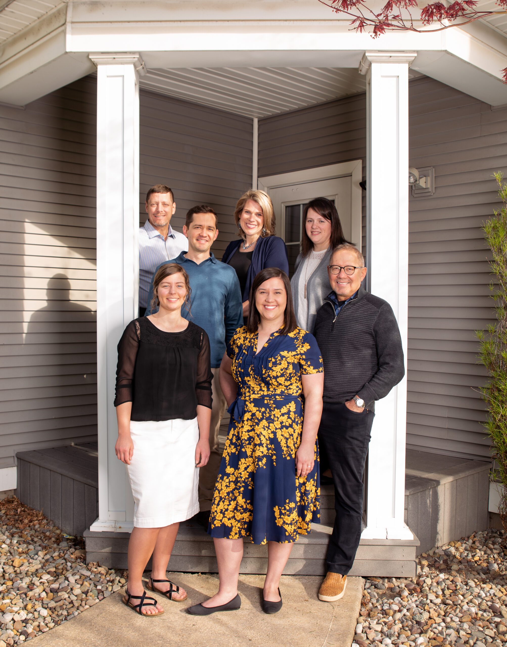 Pleasant Wealth team of financial advisors and staff standing together in the entry way to their Canton, Ohio office